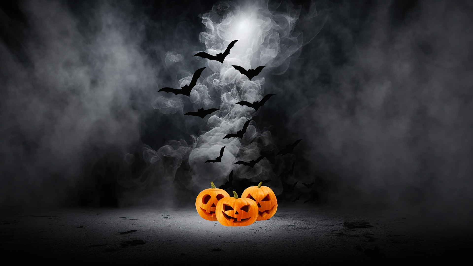 Tre halloweenpumpor och fladdermöss i bakgrunden.