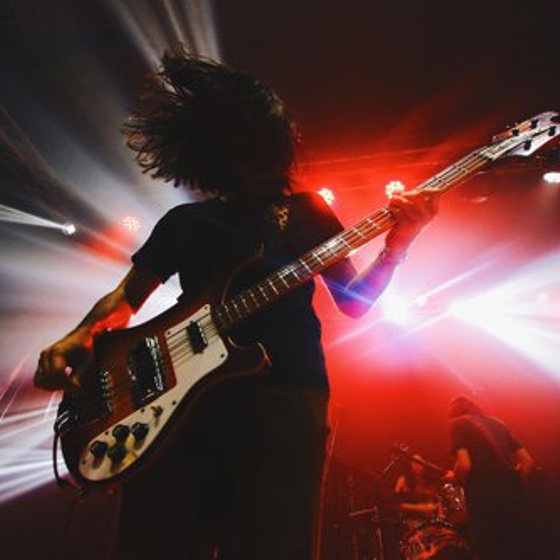 Rockmusiker spelar elgitarr på en scen.