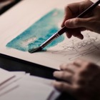 Målar en bild i aquarelle.